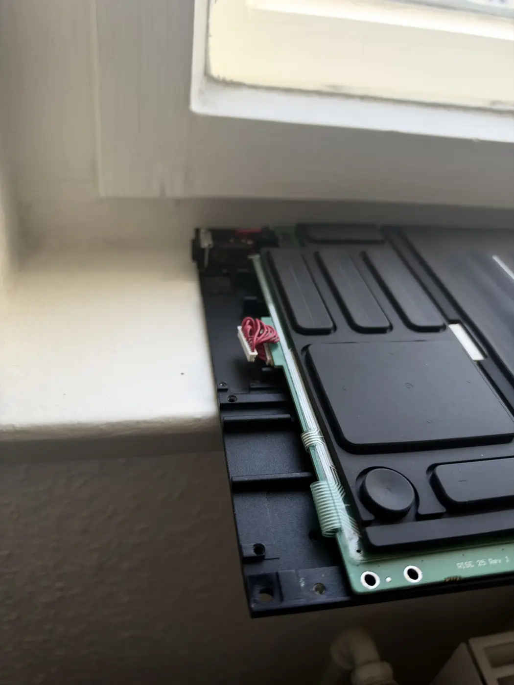 Seaboard RISE with the case open, the ports-board harness connector at the corner of the main board